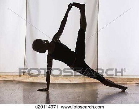 Stock Image - Woman practicing yoga. Fotosearch
