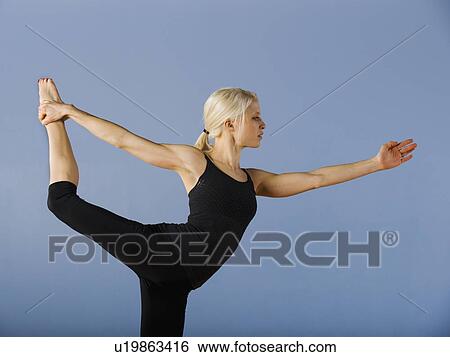 Stock Photograph - Woman practicing yoga. Fotosearch