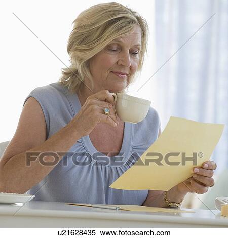 Woman reading letter at home View Large Photo Image Stock Photography - Woman reading letter at home. Fotosearch