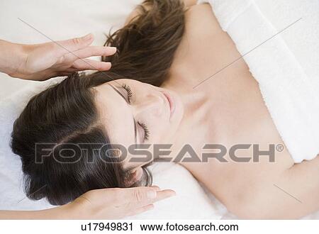 Stock Image - Woman receiving energy therapy. Fotosearch