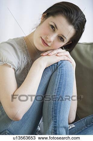 Stock Image - Woman resting head on knee. Fotosearch