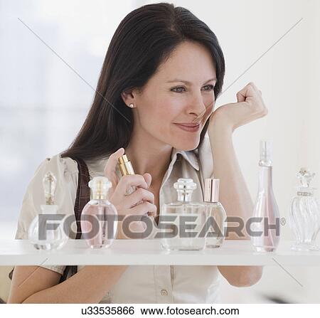 Woman sampling perfume View Large Photo Image Stock Photograph - Woman sampling perfume. Fotosearch