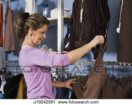 Woman shopping for clothing View Large Photo Image Stock Image - Woman shopping for clothing. Fotosearch