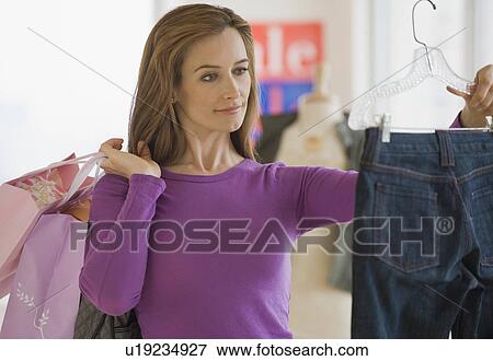 Woman shopping for clothing View Large Photo Image Stock Photo - Woman shopping for clothing. Fotosearch