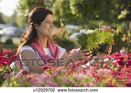 Stock Image - Woman shopping for flowers. Fotosearch