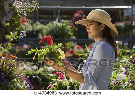 Stock Image - Woman shopping for flowers. Fotosearch