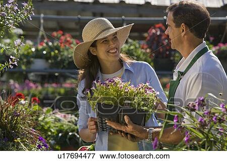 Stock Photo - Woman shopping for flowers. Fotosearch