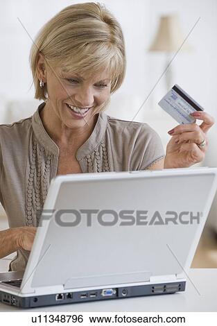 Stock Photograph - Woman shopping online. Fotosearch
