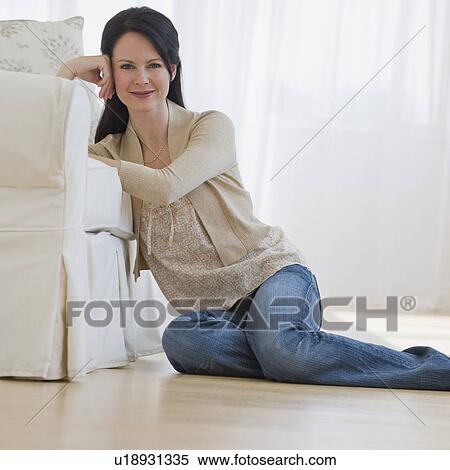 Stock Photography - Woman sitting on floor. Fotosearch