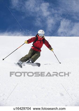 Picture - Woman skiing downhill. Fotosearch