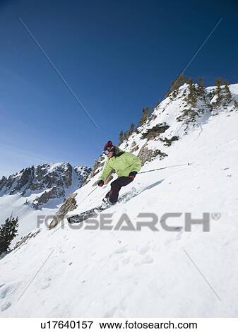 Stock Photo - Woman skiing downhill. Fotosearch