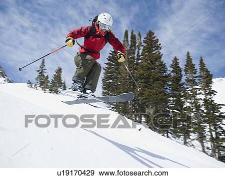 Stock Photo - Woman skiing downhill. Fotosearch