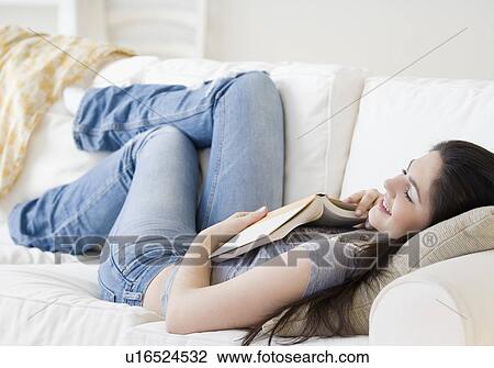 Stock Image - Woman sleeping on sofa. Fotosearch