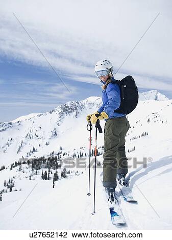 Stock Image - Woman standing on skis. Fotosearch
