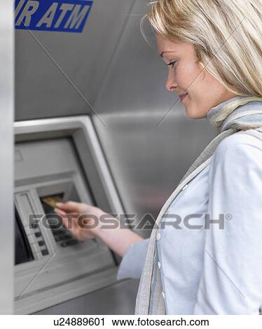 Woman using cash machine View Large Photo Image Stock Image - Woman using cash machine. Fotosearch