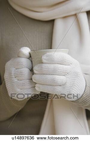 Woman wearing gloves and holding coffee mug View Large Photo Image Stock Photograph - Woman wearing gloves and holding coffee mug. Fotosearch