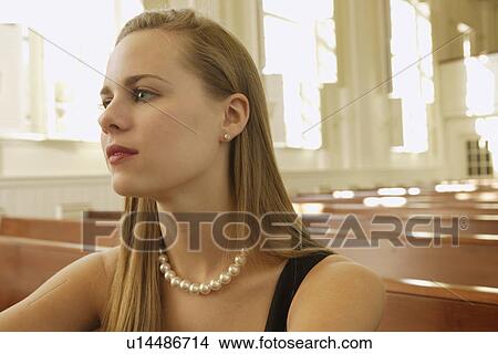 Woman wearing pearl necklace in church View Large Photo Image Picture - Woman wearing pearl necklace in church. Fotosearch