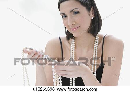 Woman wearing pearl necklace View Large Photo Image Stock Photo - Woman wearing pearl necklace. Fotosearch