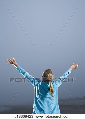 Woman with arms outstretched on foggy beach View Large Photo Image Stock Image - Woman with arms outstretched on foggy beach. Fotosearch