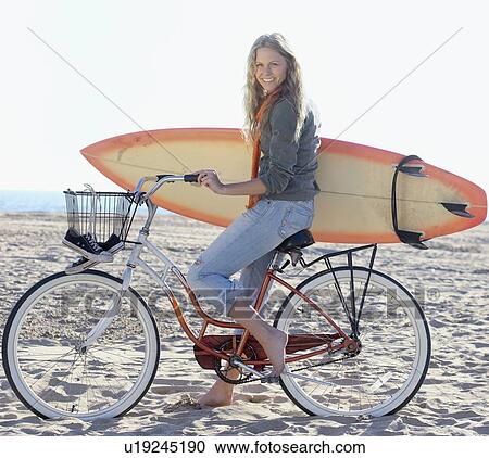 Woman with bicycle and surfboard on beach View Large Photo Image Stock Image - Woman with bicycle and surfboard on beach. Fotosearch