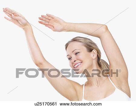 Woman with hand raised over head View Large Photo Image Stock Image - Woman with hand raised over head. Fotosearch