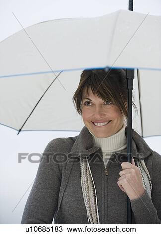 Woman with umbrella smiling View Large Photo Image Stock Image - Woman with umbrella smiling. Fotosearch