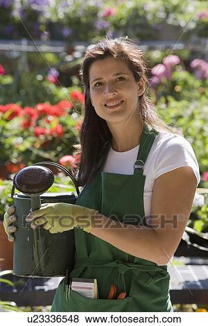 Woman working in garden center View Large Photo Image Stock Photo - Woman working in garden center. Fotosearch