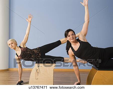 Women exercising in pilates class View Large Photo Image Stock Image - Women exercising in pilates class. Fotosearch