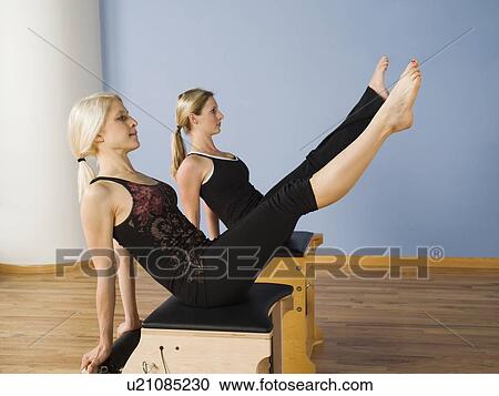 Women exercising in pilates class View Large Photo Image Stock Image - Women exercising in pilates class. Fotosearch