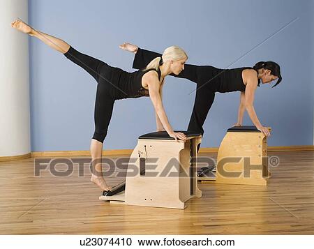 Women exercising in pilates class View Large Photo Image Stock Image - Women exercising in pilates class. Fotosearch
