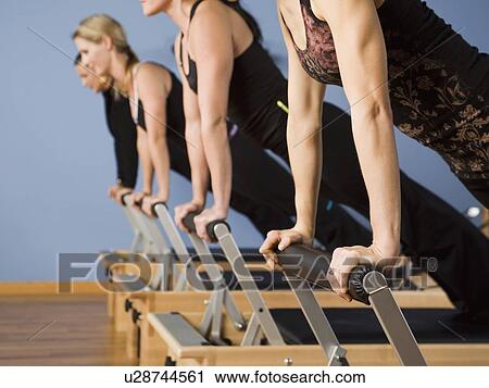 Women exercising in pilates class View Large Photo Image Stock Image - Women exercising in pilates class. Fotosearch