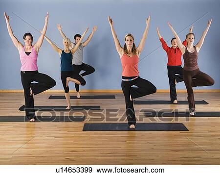 Women exercising in yoga class View Large Photo Image Stock Photo - Women exercising in yoga class. Fotosearch