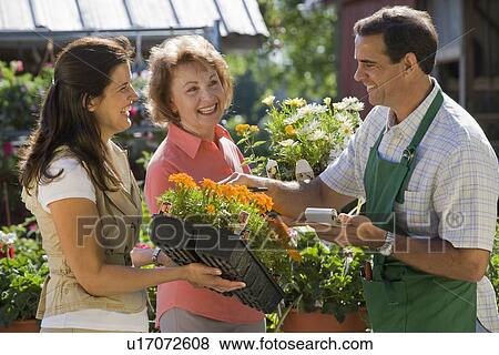Stock Photo - Women paying for flowers. Fotosearch
