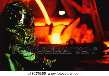 Worker in asbestos suit working in steel foundry View Large Photo Image Stock Photography - Worker in asbestos suit working in steel foundry. Fotosearch