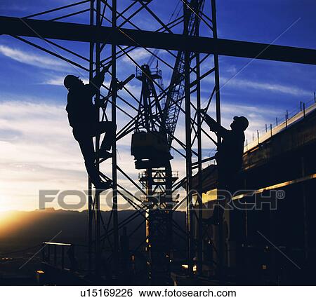 Stock Photograph - Workers climbing towers of construction site in Las Vegas. Fotosearch