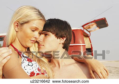 Young couple hugging on beach View Large Photo Image Stock Image - Young couple hugging on beach. Fotosearch