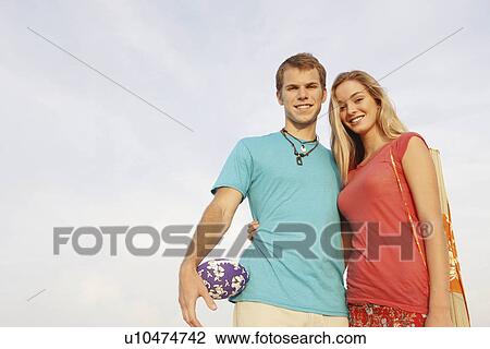 Stock Image - Young couple posing at beach. Fotosearch