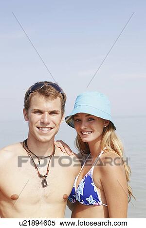 Stock Photography - Young couple posing at beach. Fotosearch