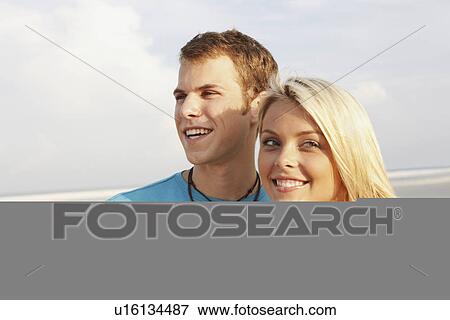 Young couple posing on beach View Large Photo Image Stock Photo - Young couple posing on beach. Fotosearch