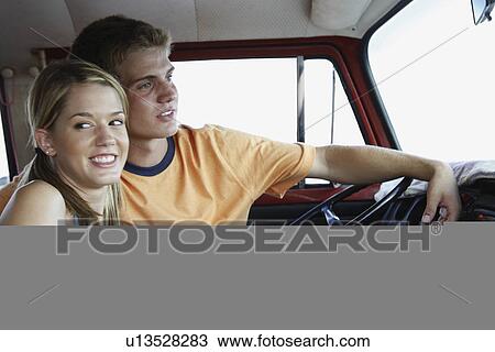 Young couple sitting in van on beach View Large Photo Image Stock Image - Young couple sitting in van on beach. Fotosearch