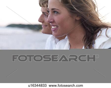 Young couple wrapped in blankets on beach View Large Photo Image Stock Image - Young couple wrapped in blankets on beach. Fotosearch