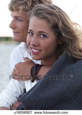 Young couple wrapped in blankets on beach View Large Photo Image Stock Photo - Young couple wrapped in blankets on beach. Fotosearch
