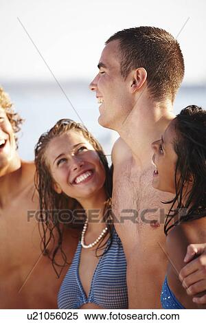 Young couples laughing on beach View Large Photo Image Stock Photography - Young couples laughing on beach. Fotosearch