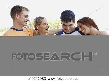 Young couples posing on beach View Large Photo Image Stock Image - Young couples posing on beach. Fotosearch