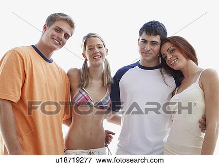 Young couples posing on beach View Large Photo Image Stock Photo - Young couples posing on beach. Fotosearch