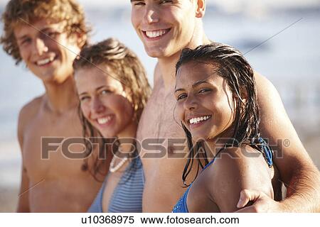 Young couples posing on beach View Large Photo Image Stock Photography - Young couples posing on beach. Fotosearch
