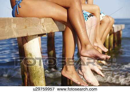 Young friends sitting on dock View Large Photo Image Stock Photo - Young friends sitting on dock. Fotosearch