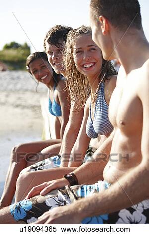 Young friends sitting on dock View Large Photo Image Stock Photography - Young friends sitting on dock. Fotosearch