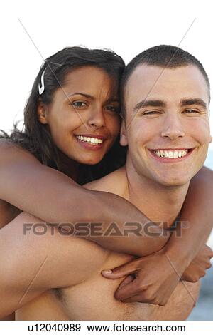 Young man carrying girlfriend on back View Large Photo Image Stock Photo - Young man carrying girlfriend on back. Fotosearch