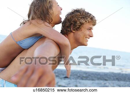 Young man carrying girlfriend on back View Large Photo Image Stock Photography - Young man carrying girlfriend on back. Fotosearch